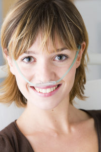 image of woman supplementing oxygen through a nasal cannula